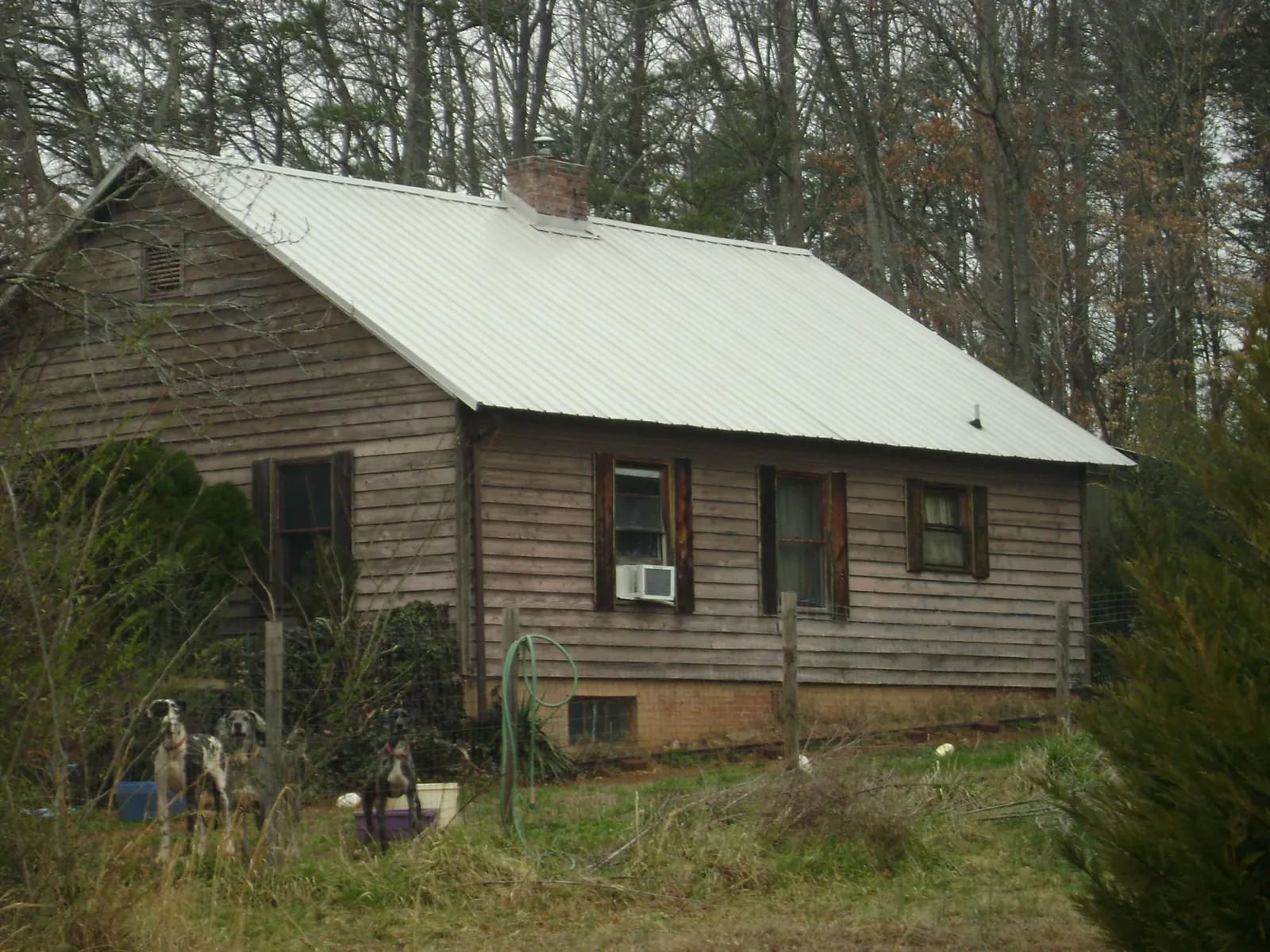 White metal roof on an old wood sided farmhouse, from a Metal Roof Installation job in Roosevelt